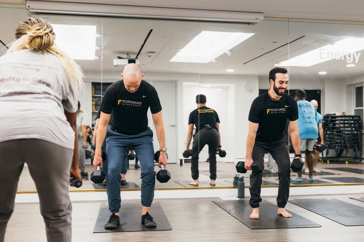 Runners performing strength training exercises in a Boston studio