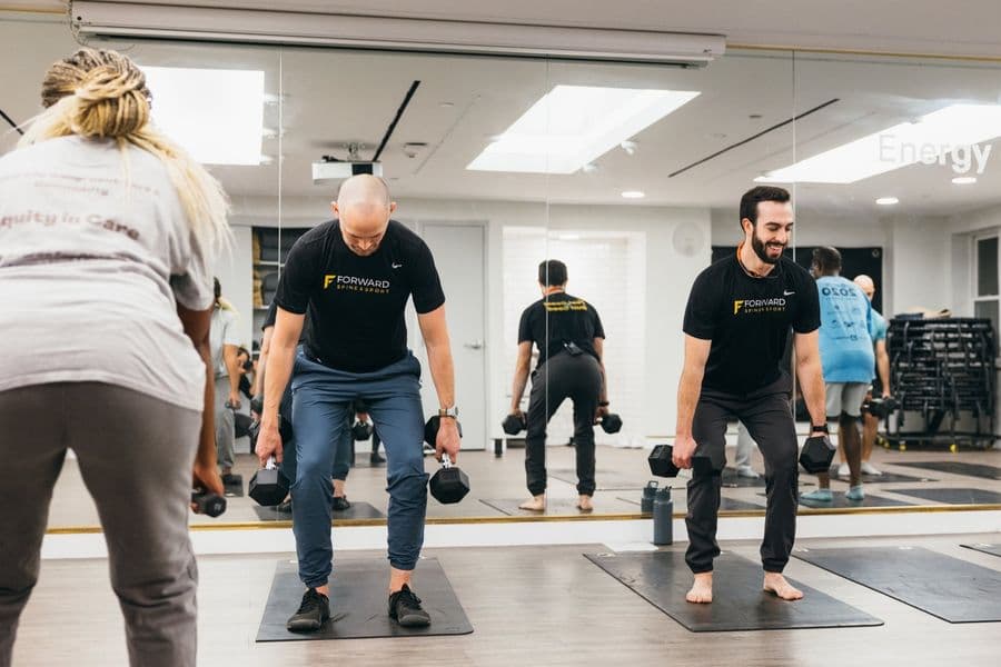 Runners performing strength training exercises in a Boston studio