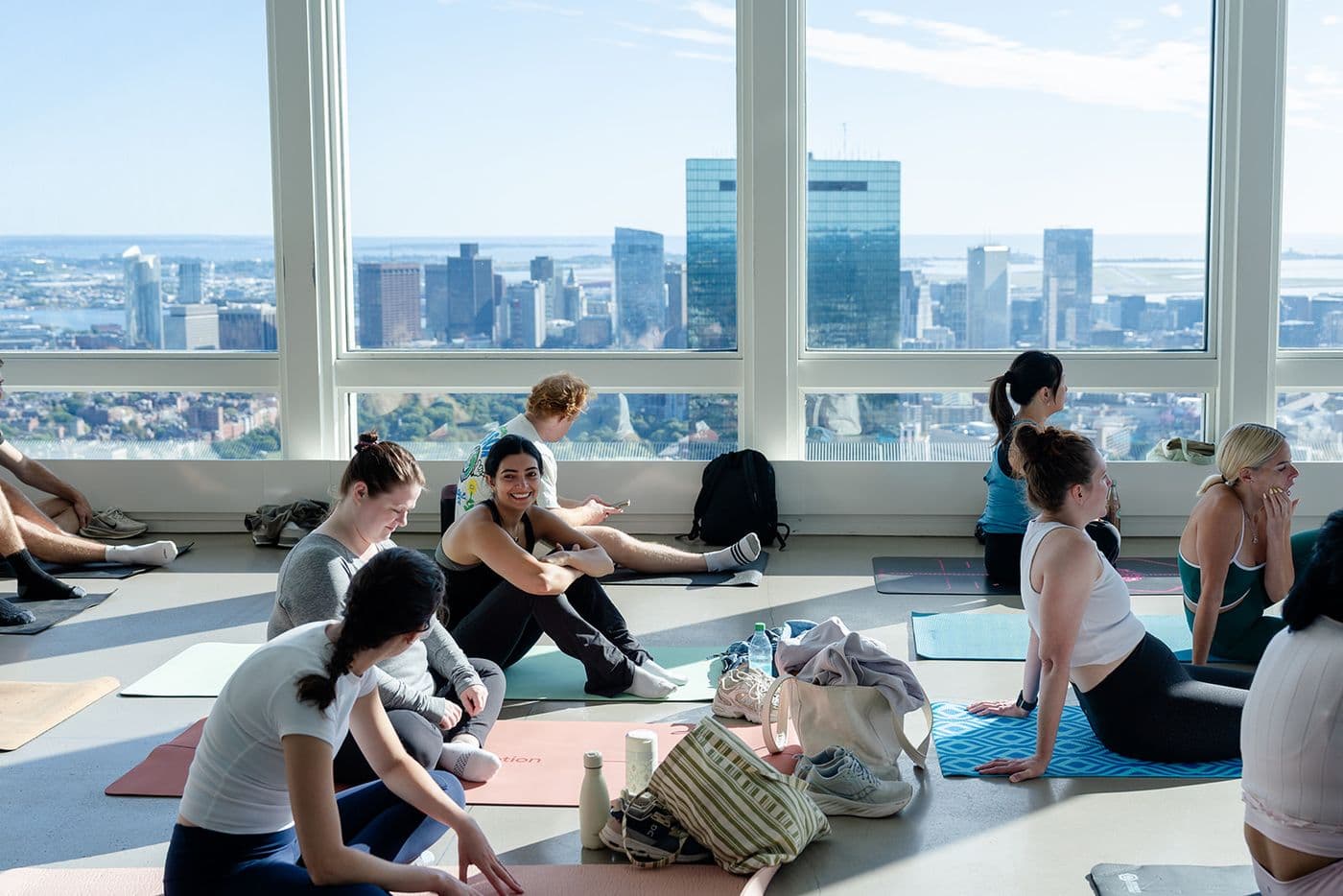 Group fitness participants working out together at a Boston fitness studio, highlighting strength training and community fitness trends.