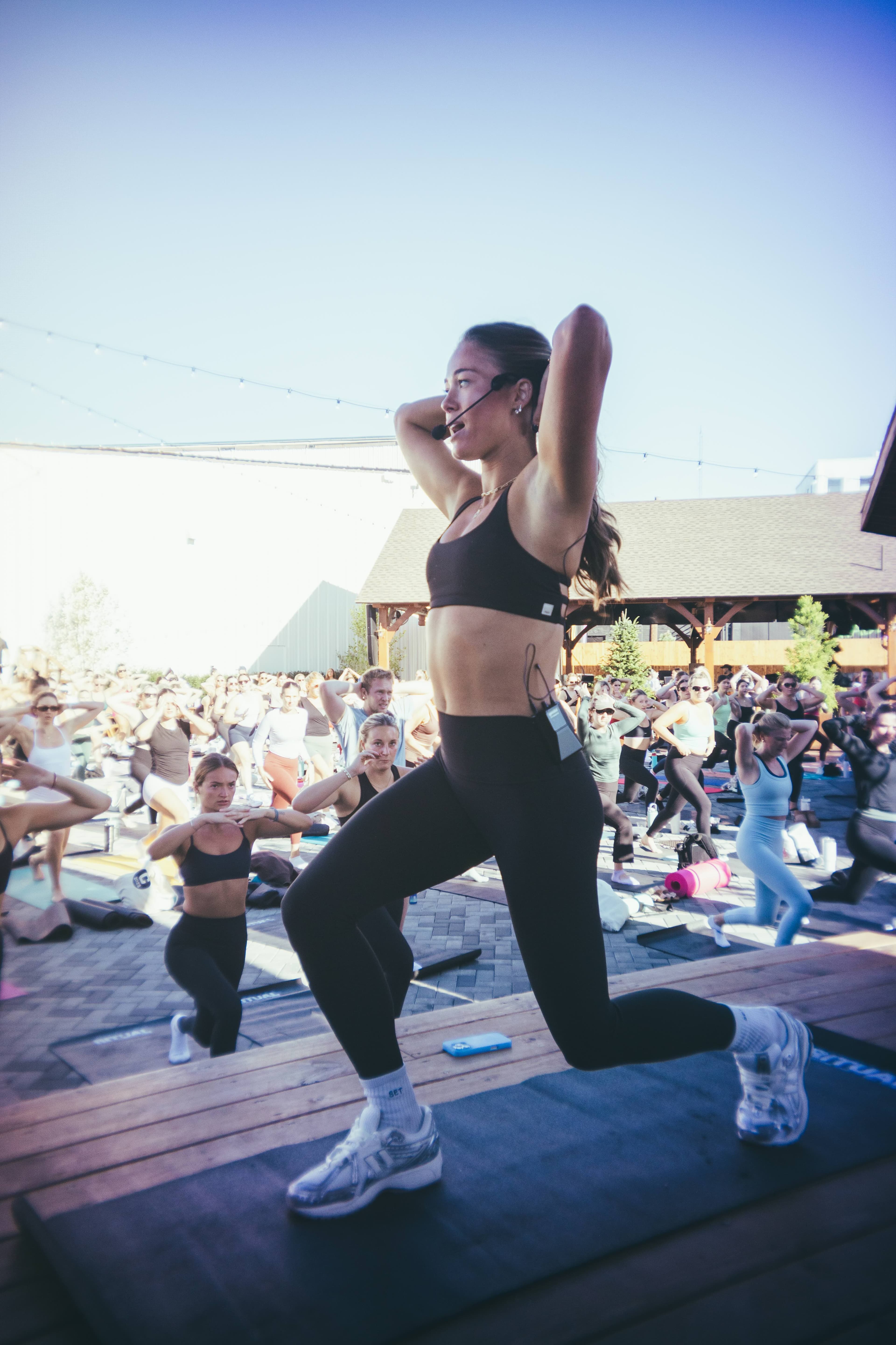 Emma Ellis, Boston-based fitness instructor, leading the Outdoor DJ Sculpt class at the End of Summer Send-Off at View Boston.